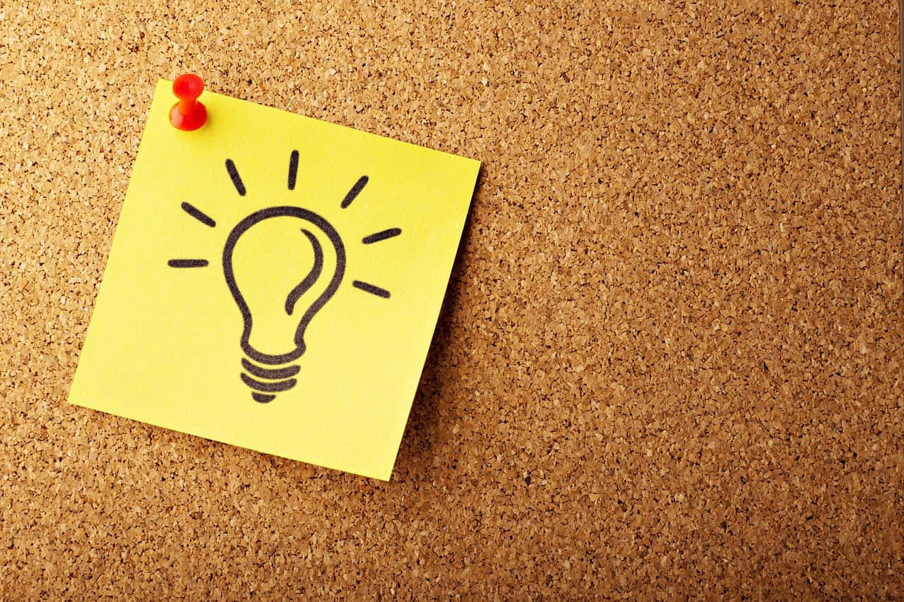 A Yellow Post It Note With A Light Bulb Drawn On It