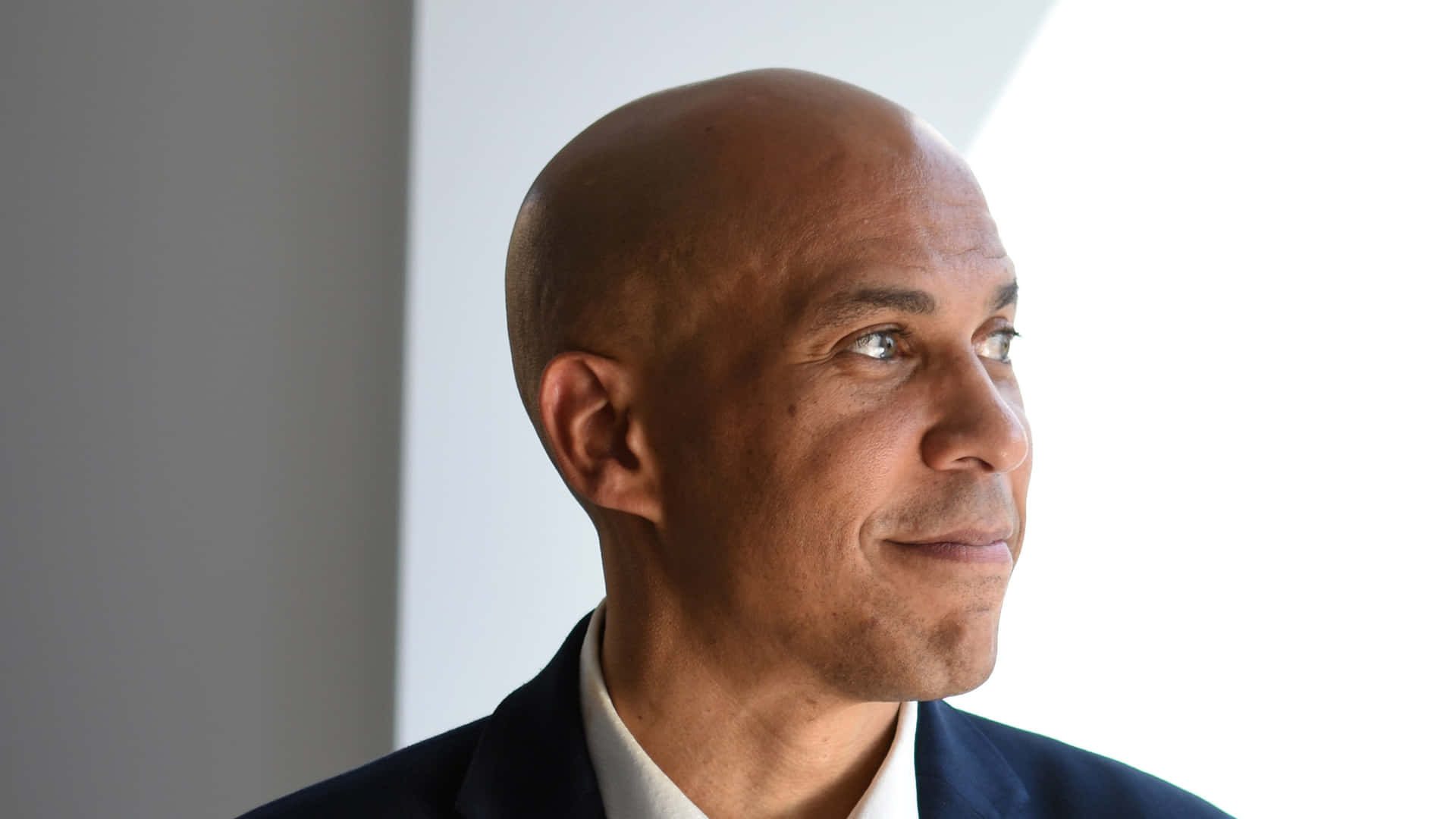 Cory Booker exuding charisma with a captivating smile Wallpaper