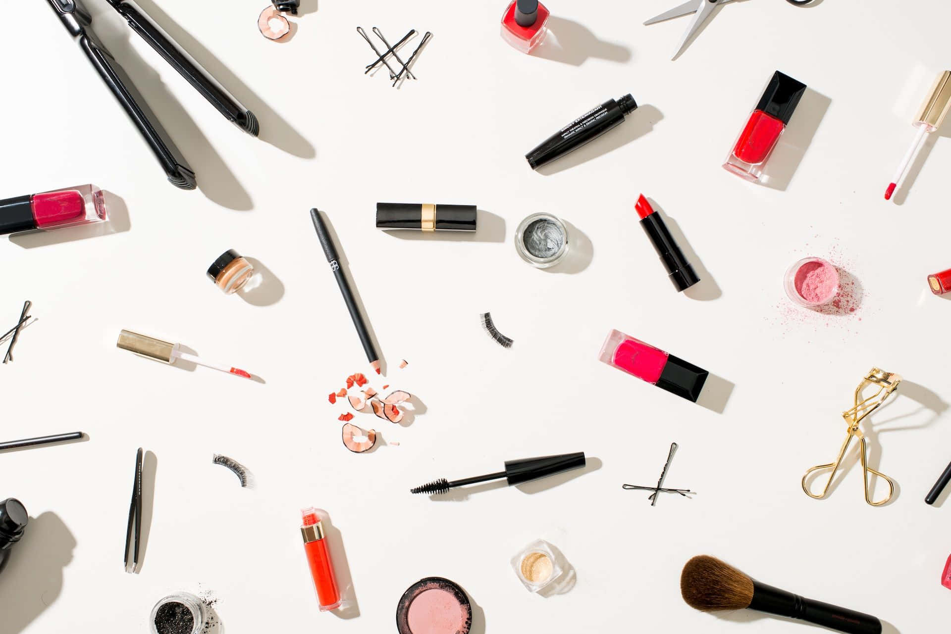 A Variety Of Makeup Products Are Arranged On A White Surface