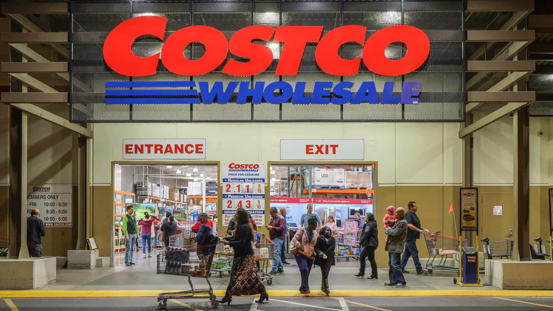 Costco Wholesale Is A Large Store With People Walking In Front Of It