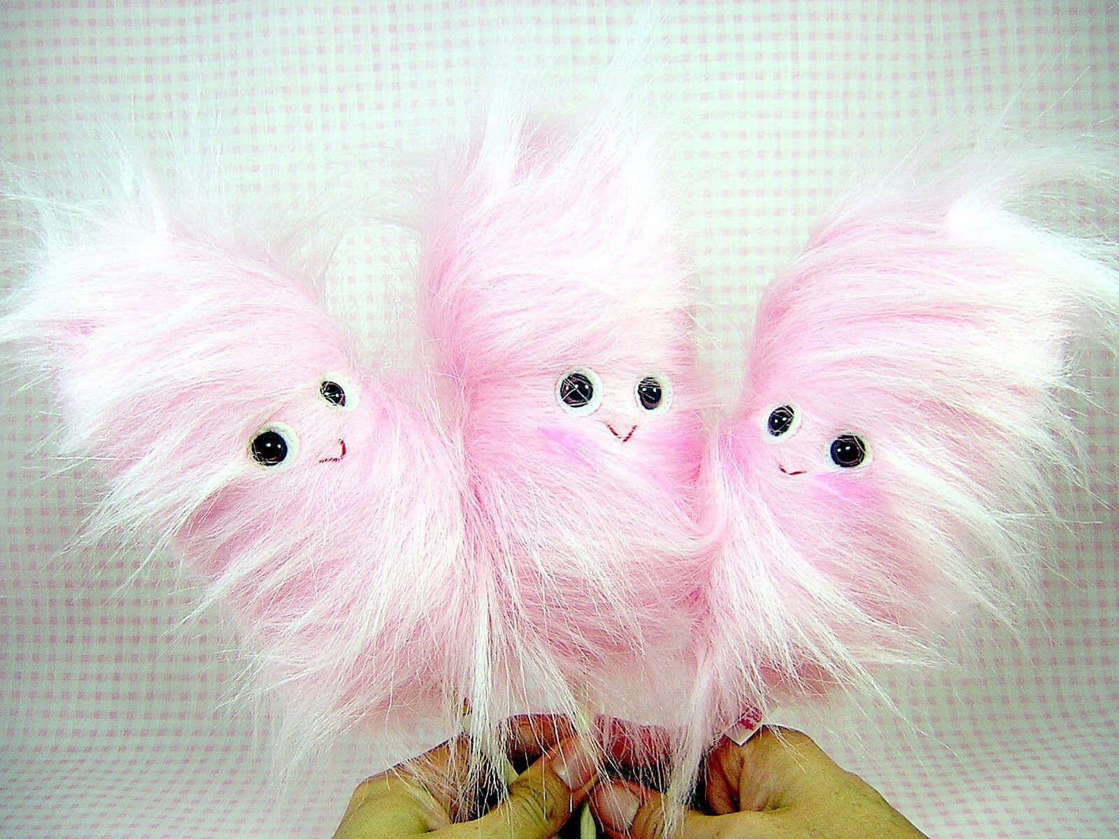 Adorable Three Pink Cotton Candy Plush Toys Background