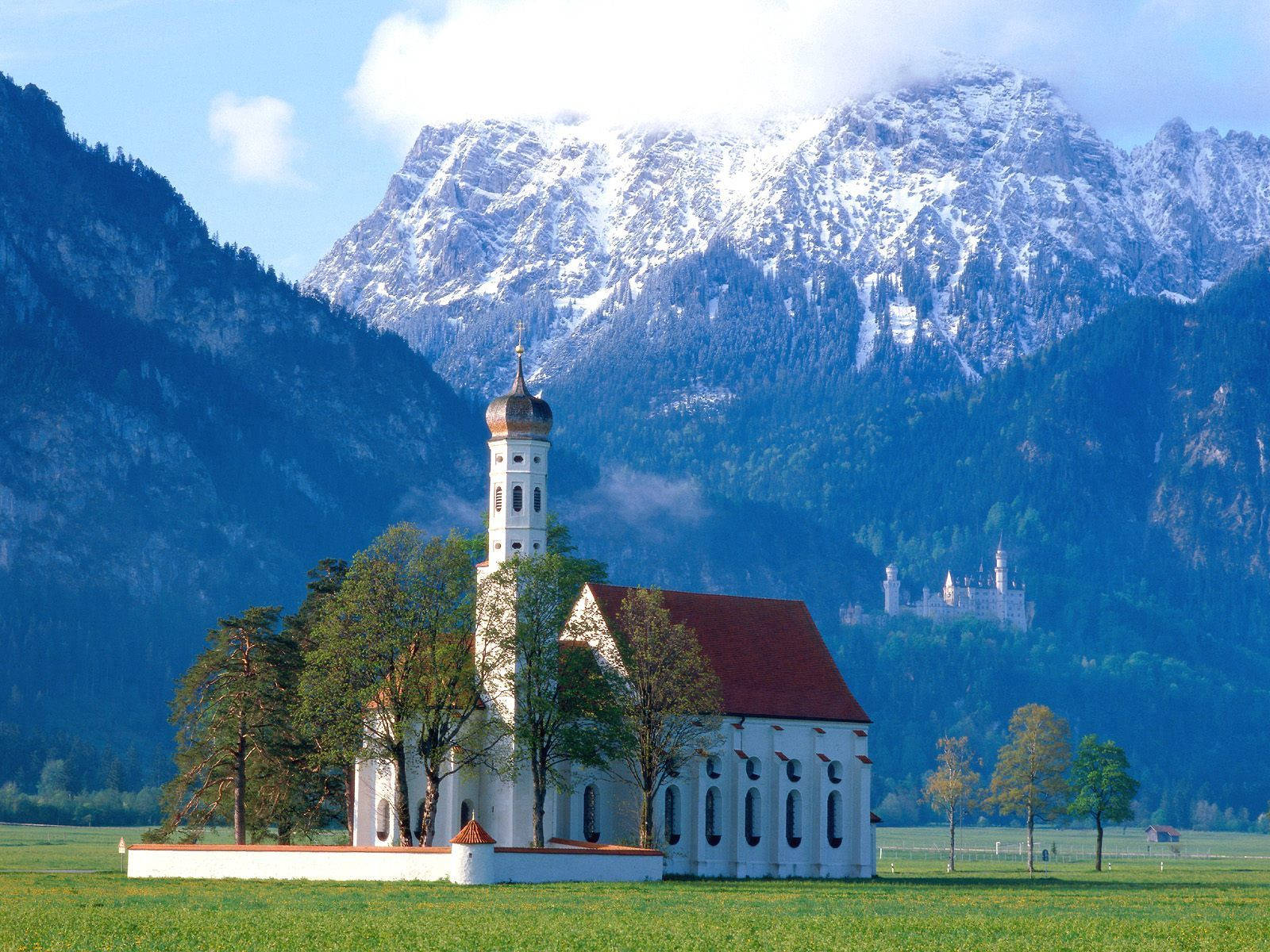An idylic scene of a mountain-top country church Wallpaper