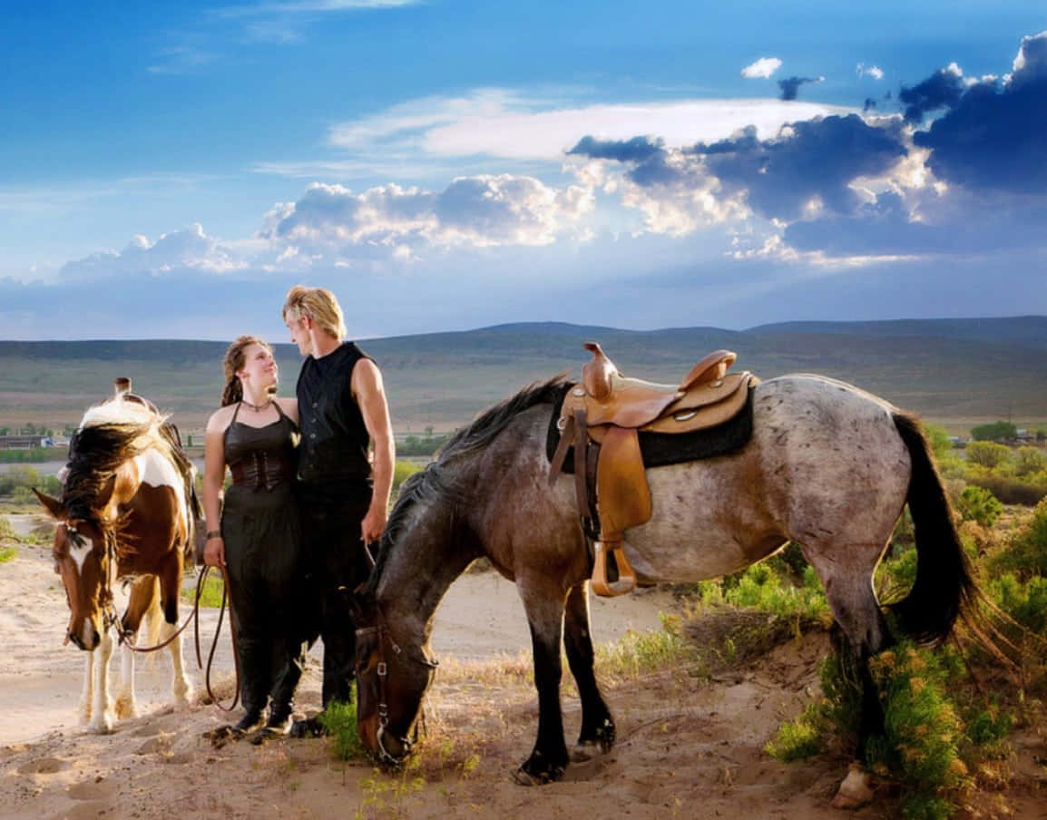 Landskab på foto med ægtepar og deres heste.