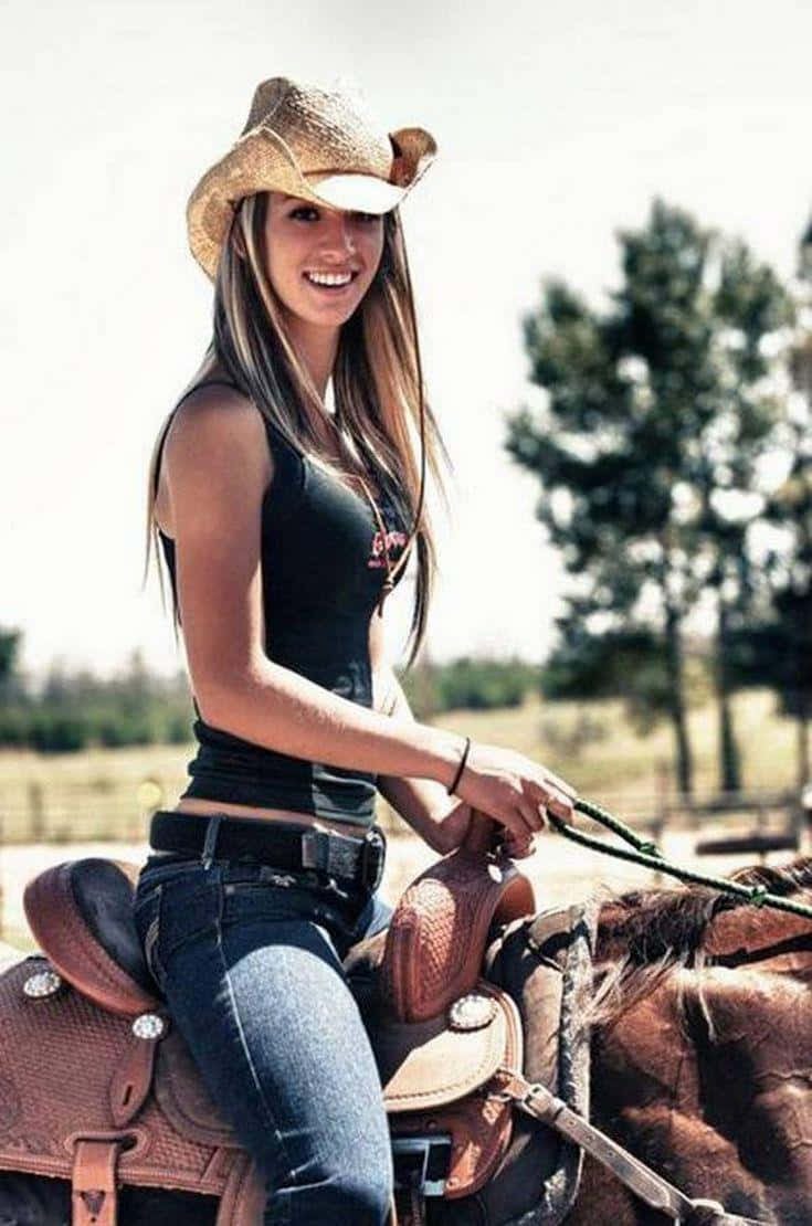 Envacker Kvinna Som Rider På En Häst Med En Cowboyhatt Wallpaper