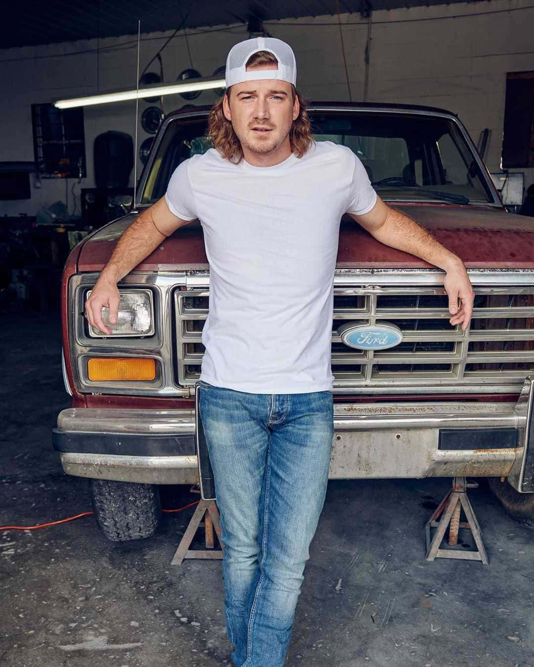 Country Music Artist Leaningon Old Truck Wallpaper