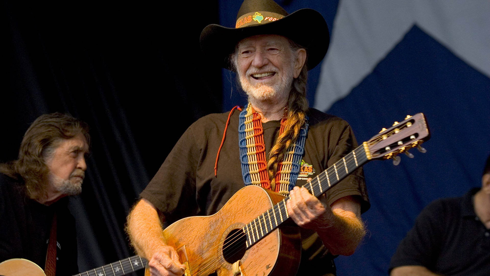 Country Musician Willie Nelson With Guitar Wallpaper
