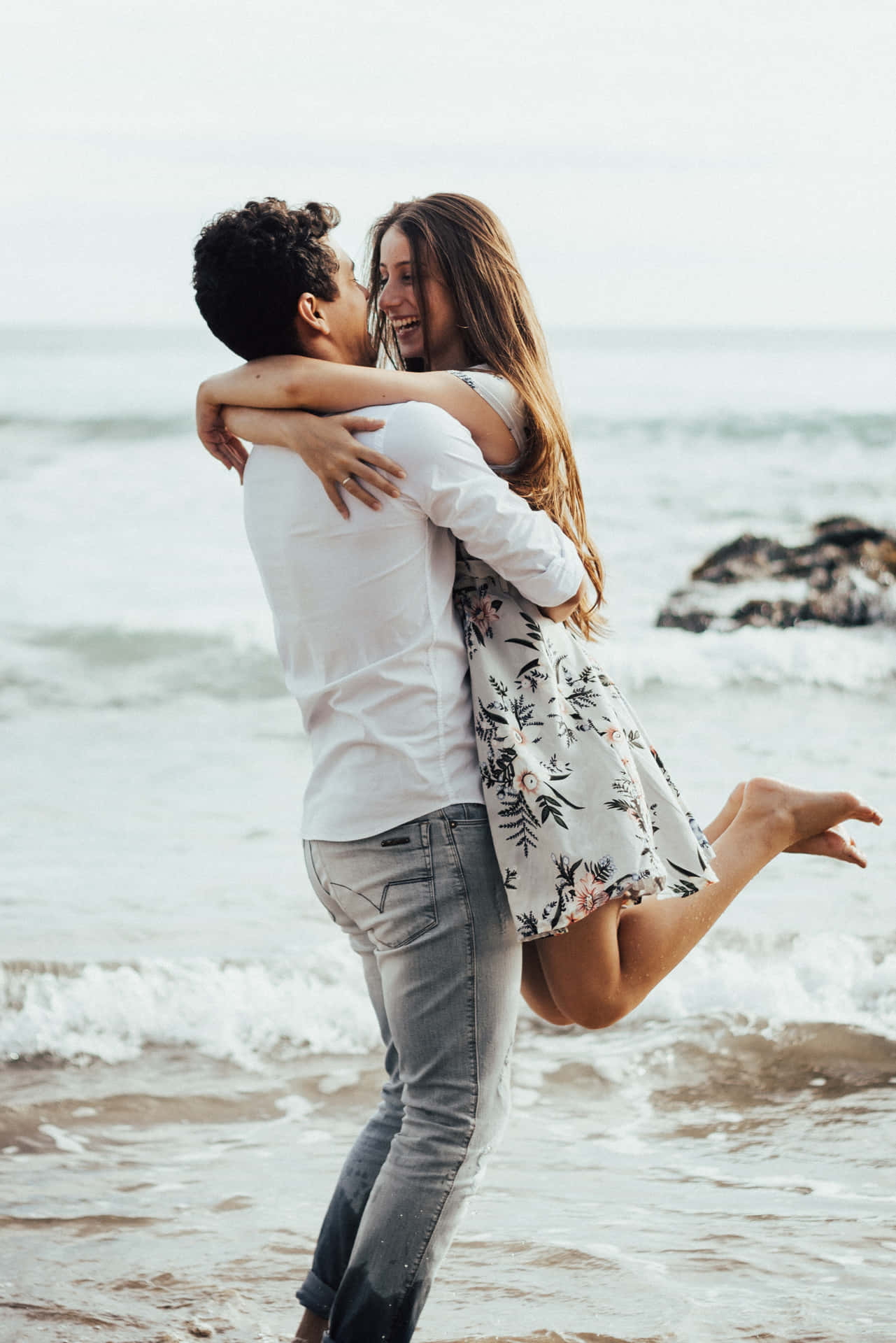Couple At Beach Hugging Partner Wallpaper