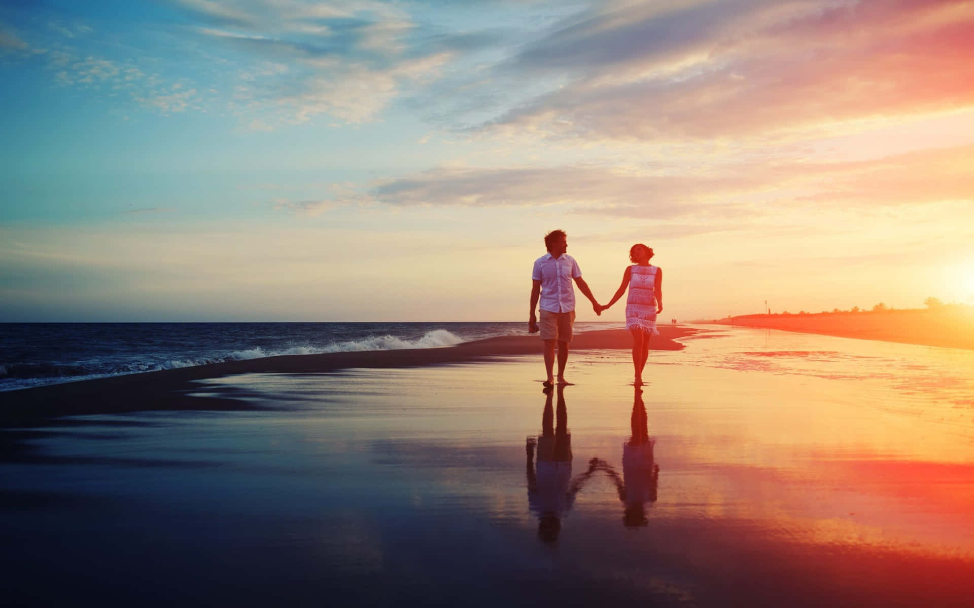 Couple At Beach On Wet Section Sunset Shot Wallpaper
