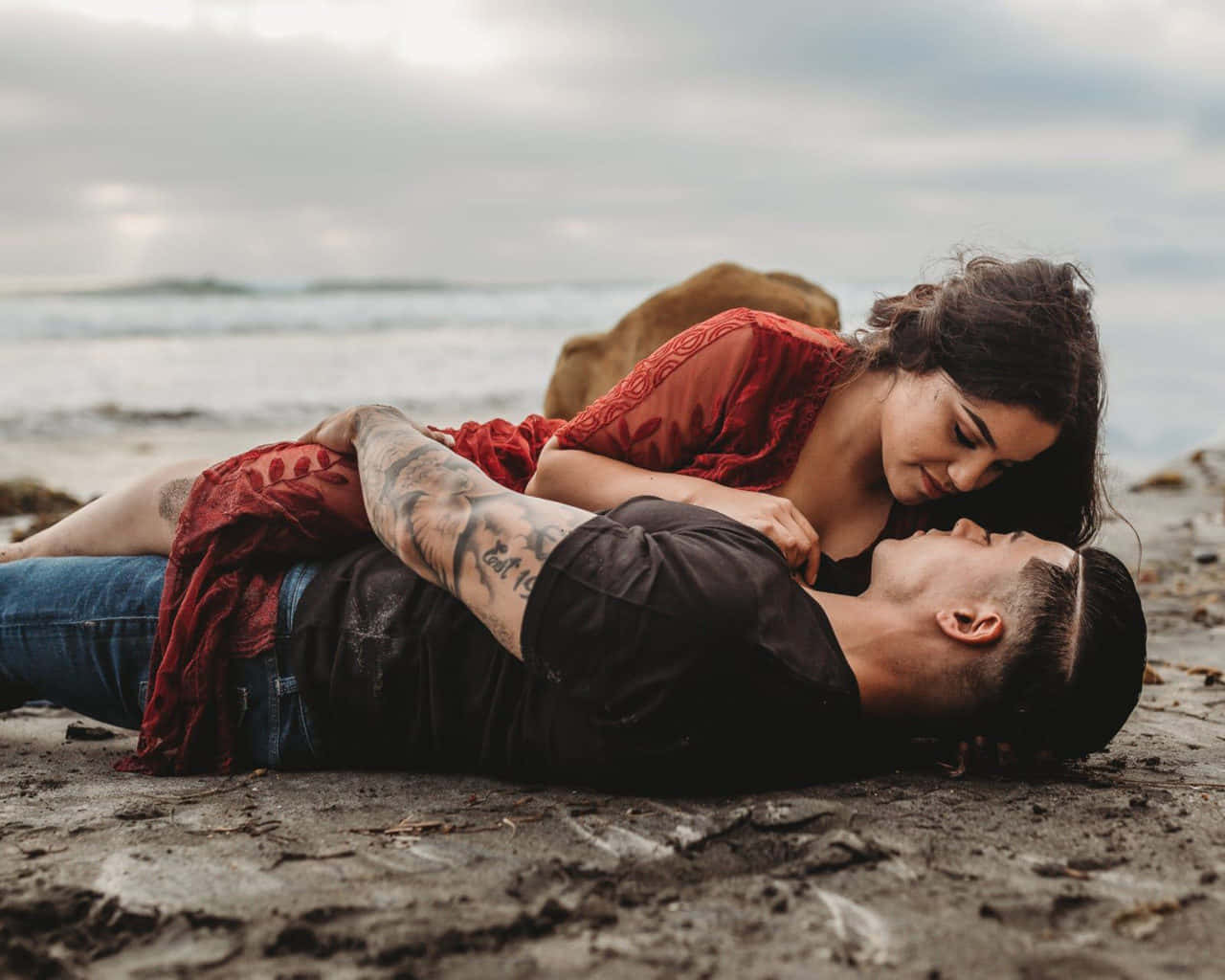Couple At Beach Laying On Rocks Picture