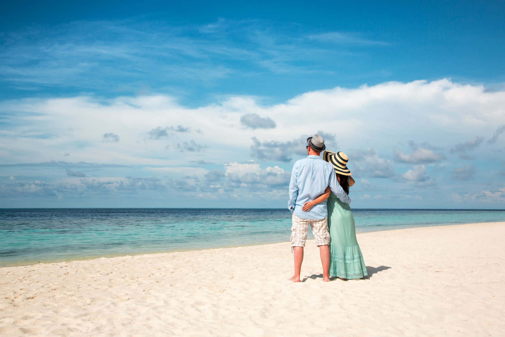 Couple At Beach Standing Under Blue Sky Picture