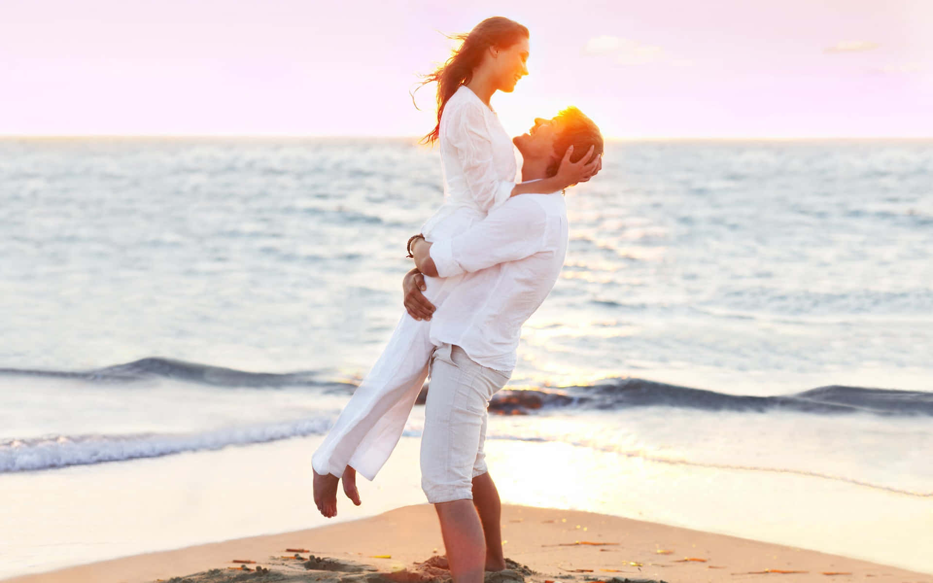 Couple At Beach In White Clothes Carrying Picture