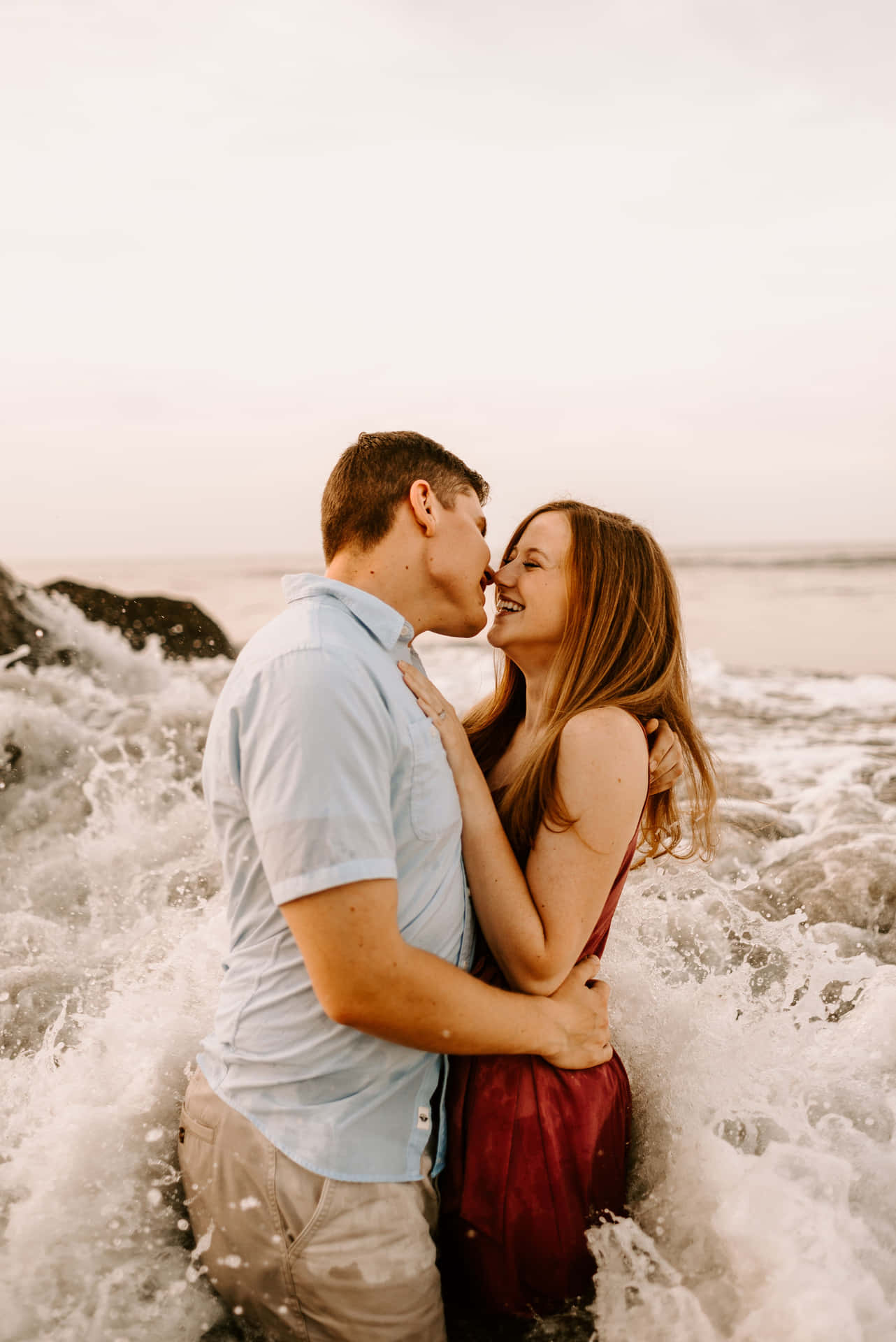 Couple At Beach Waves Crashing While Kissing Picture