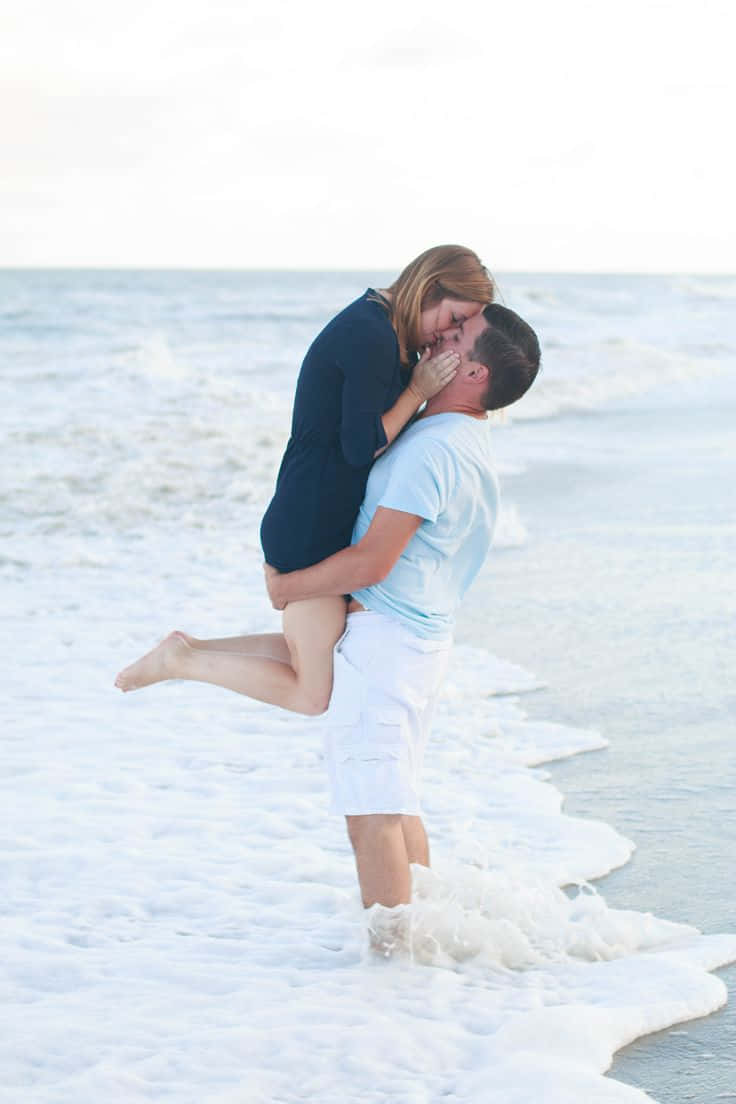 Couple At Beach Kissing And Carrying Picture
