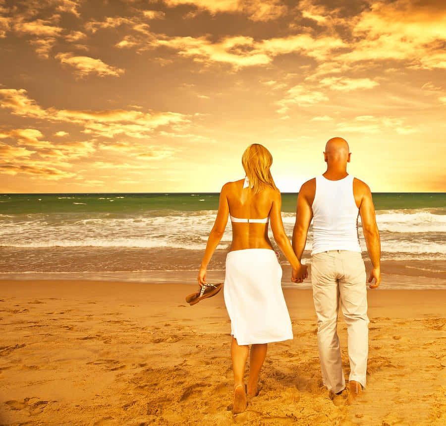 Couple At Beach Under Orange Sky Picture