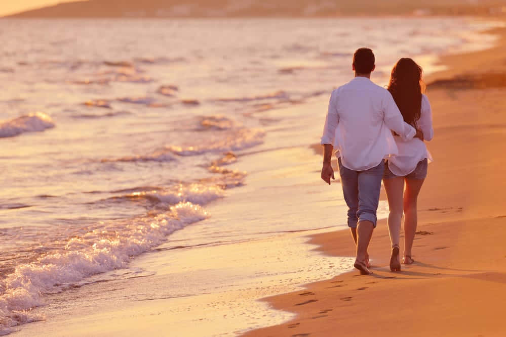 Couple At Beach On Shore During Sunset Picture