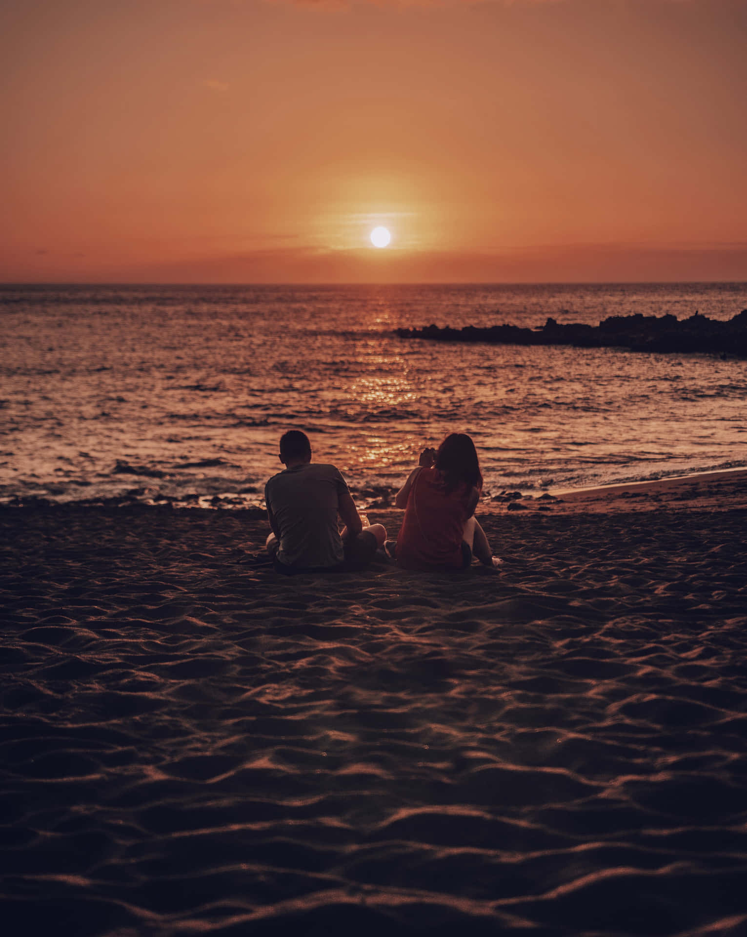 Download Couple At Beach Sunset Photograph Wallpaper 