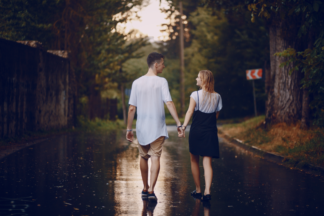 Young Couple Walking On A Rainy Street