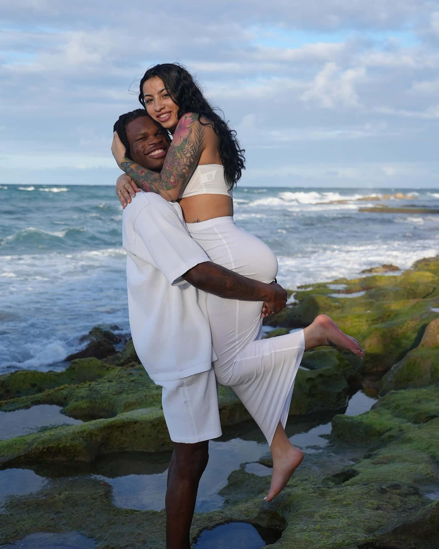 Couple Embrace Beachside Wallpaper