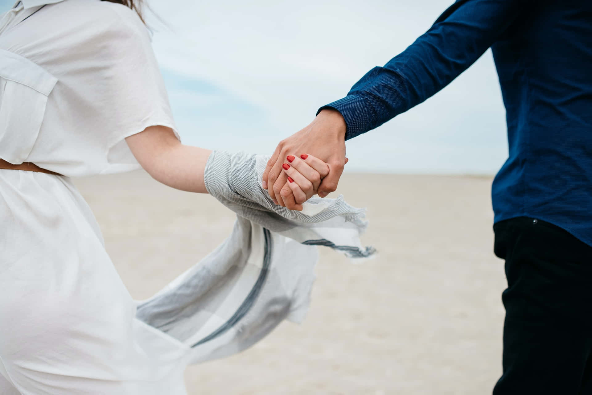 Couple Holding Hands Beach Walk Wallpaper