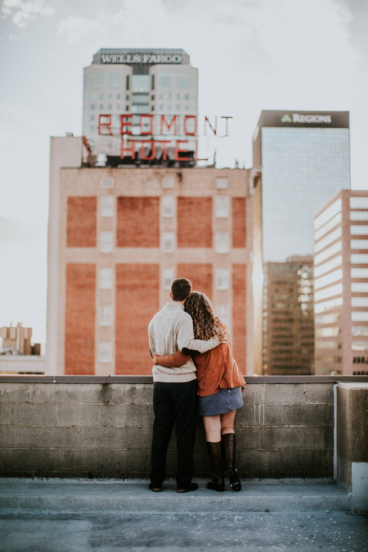 Couple Hugging Side By Side Downtown Birmingham Rooftop Wallpaper