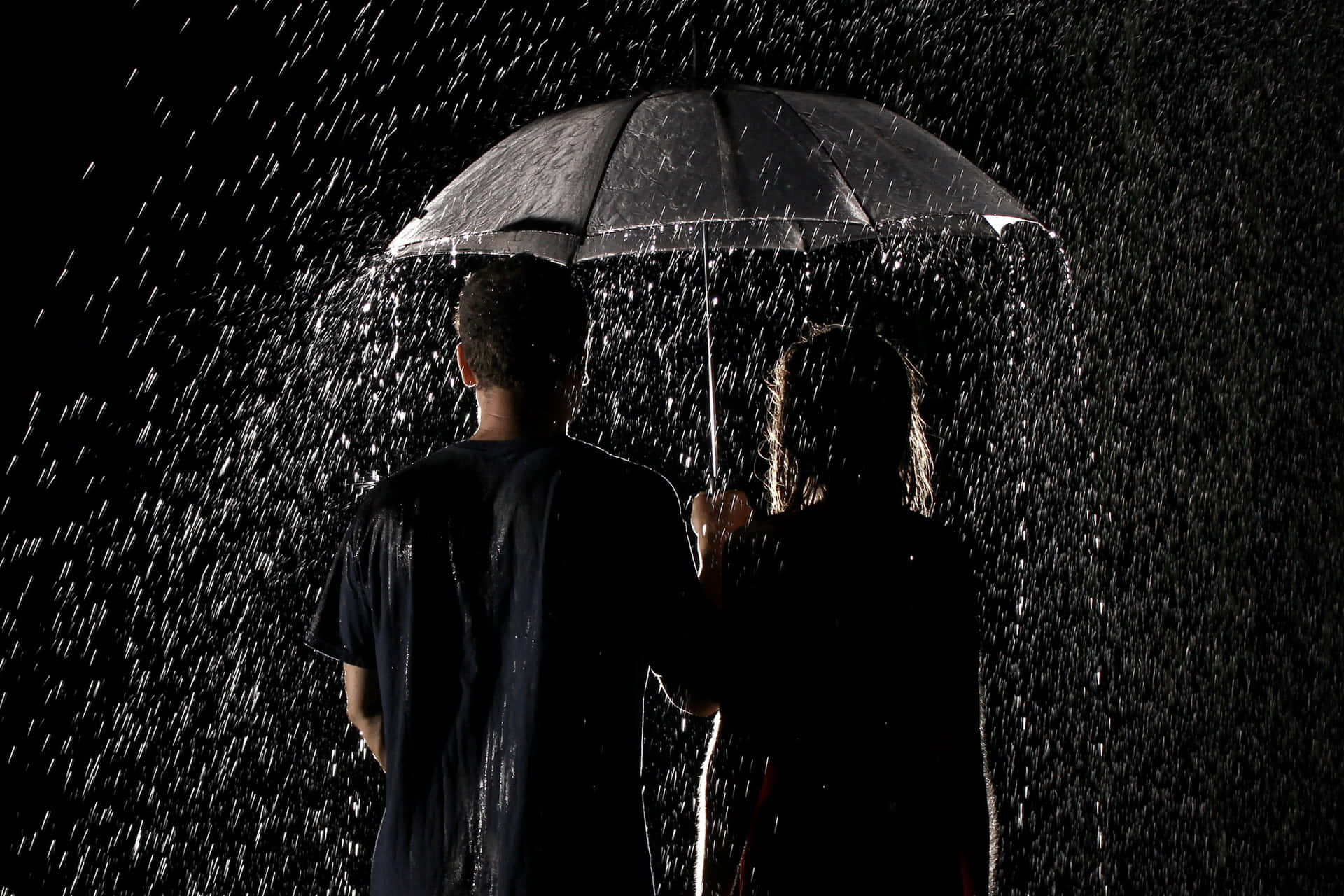 A romantic couple enjoying the rain
