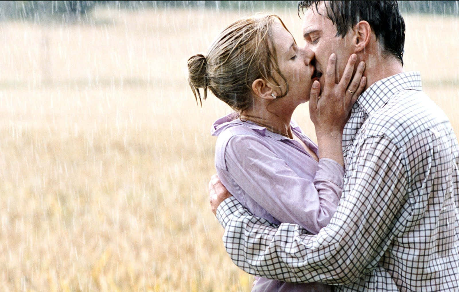 A romantic moment beneath the rain.