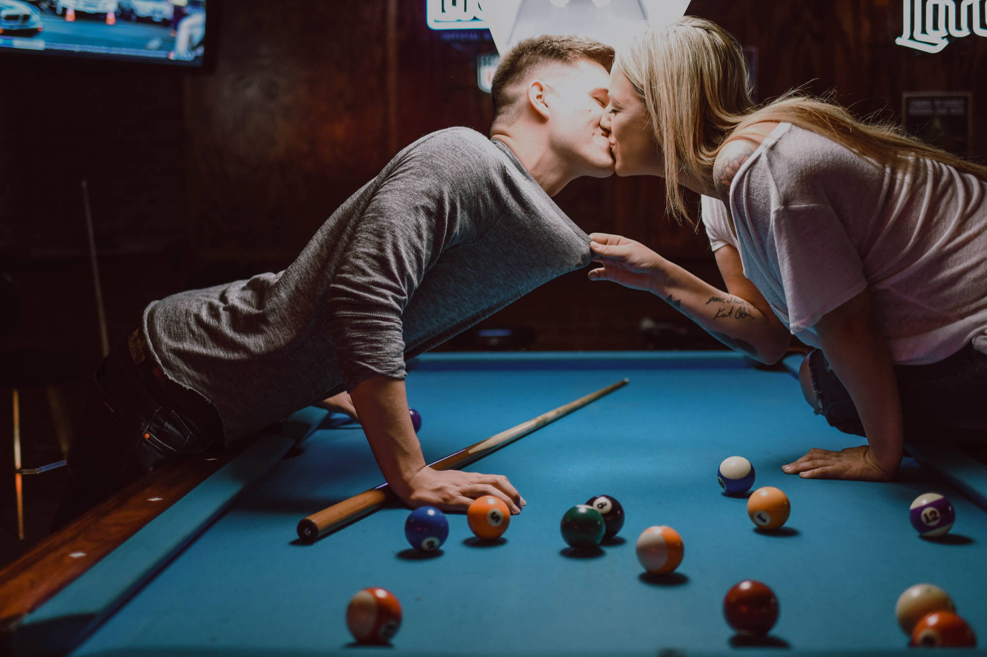 Couple Kissing On Billiard Table Wallpaper