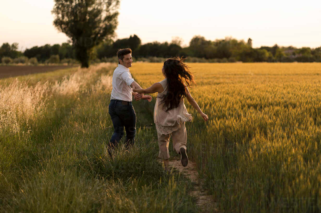 Couple Running In The Field Picture