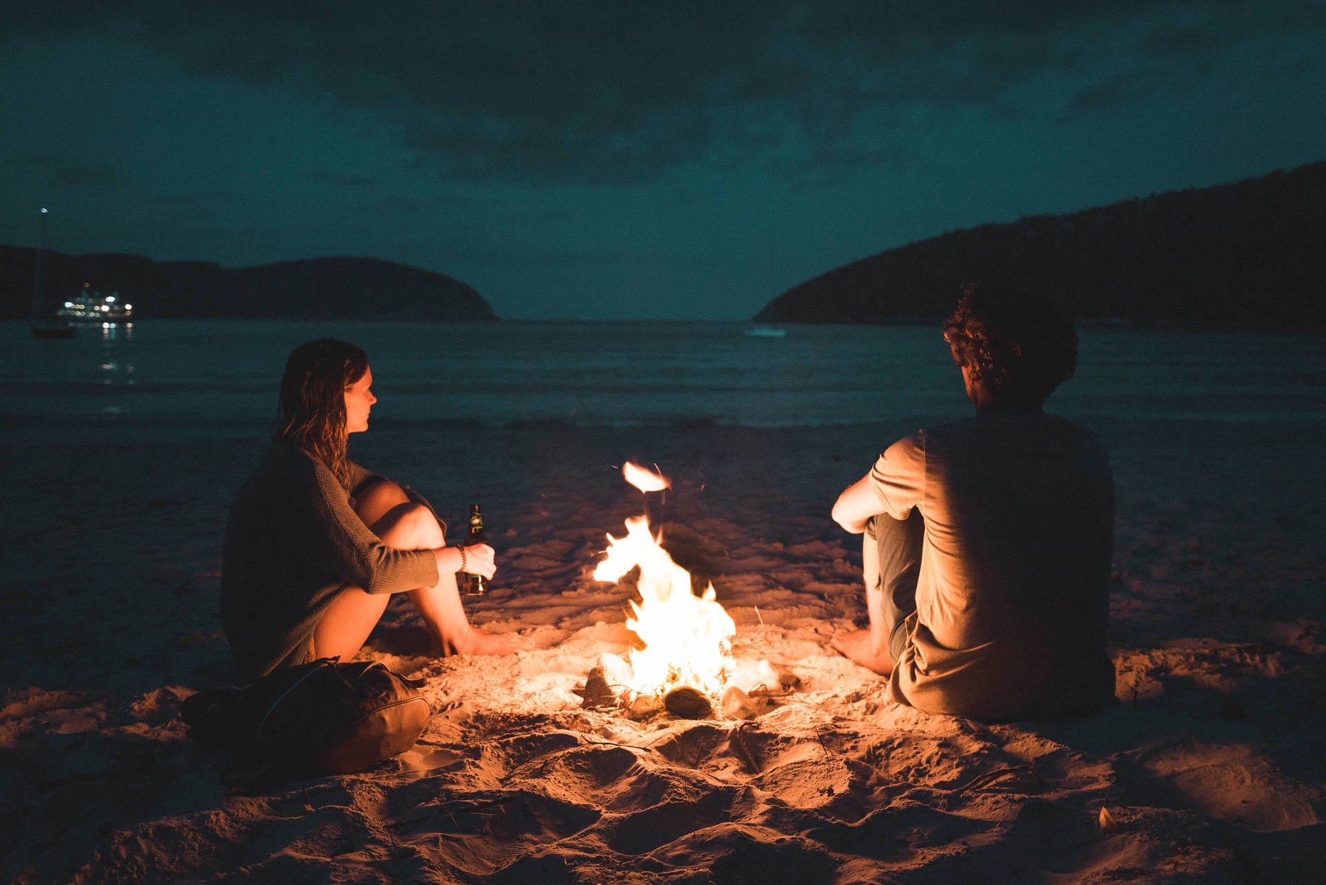 Couple Sitting Beside Bonfire Background