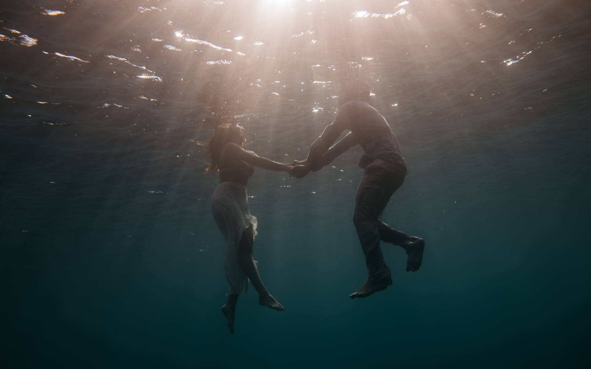Couple Swimming Under The Ocean Wallpaper