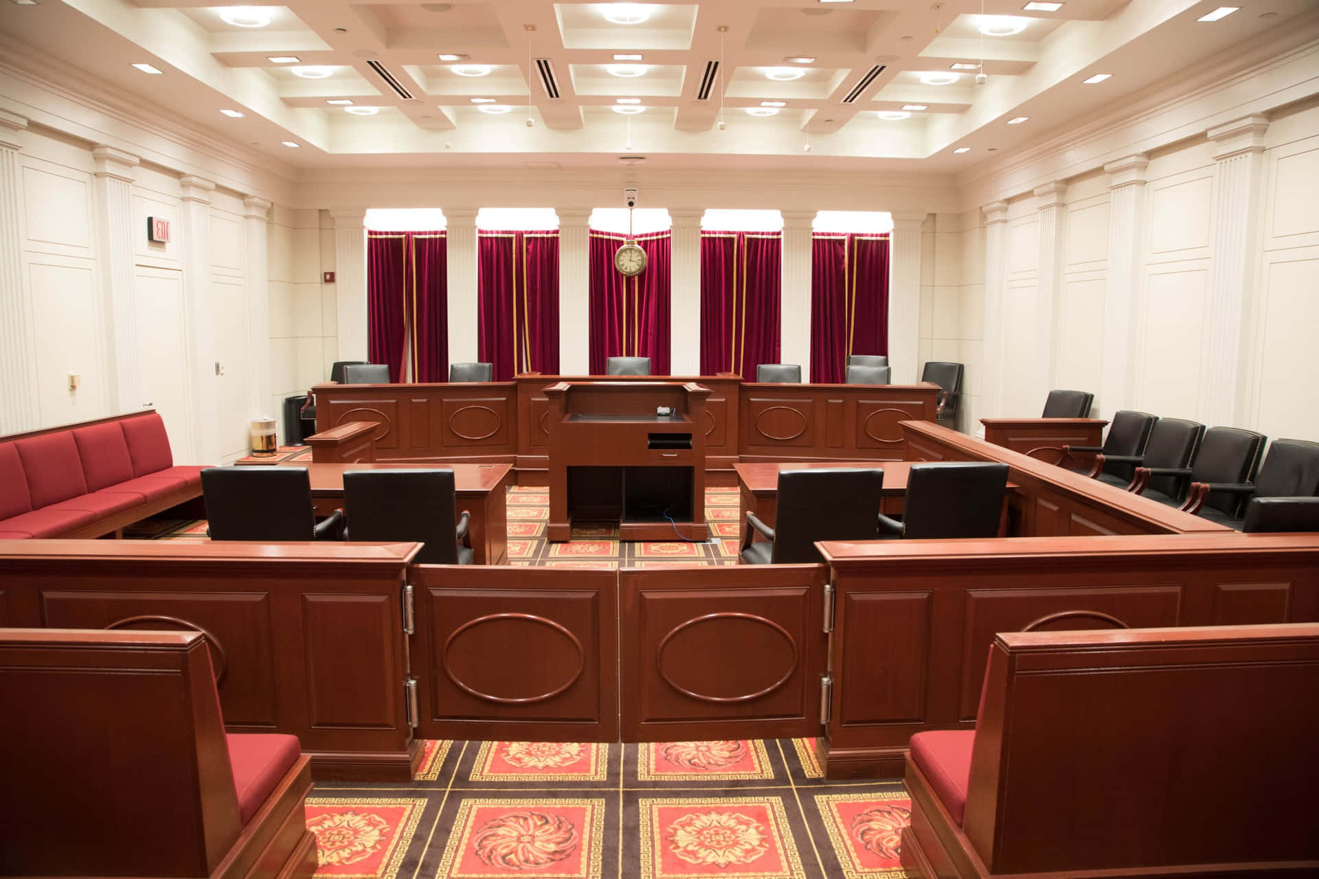 A Courtroom With Red Benches