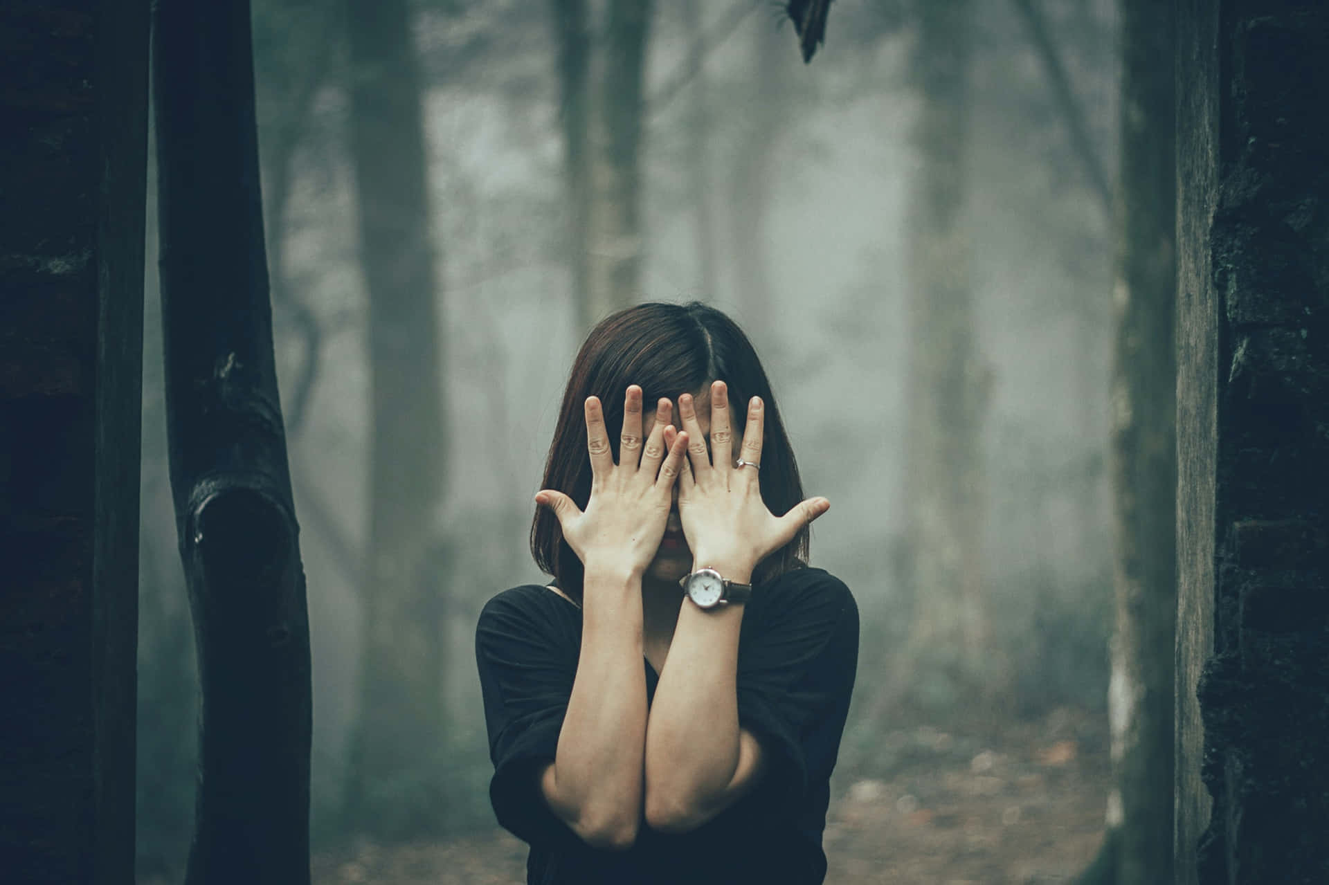 Woman Covering Her Face In The Forest