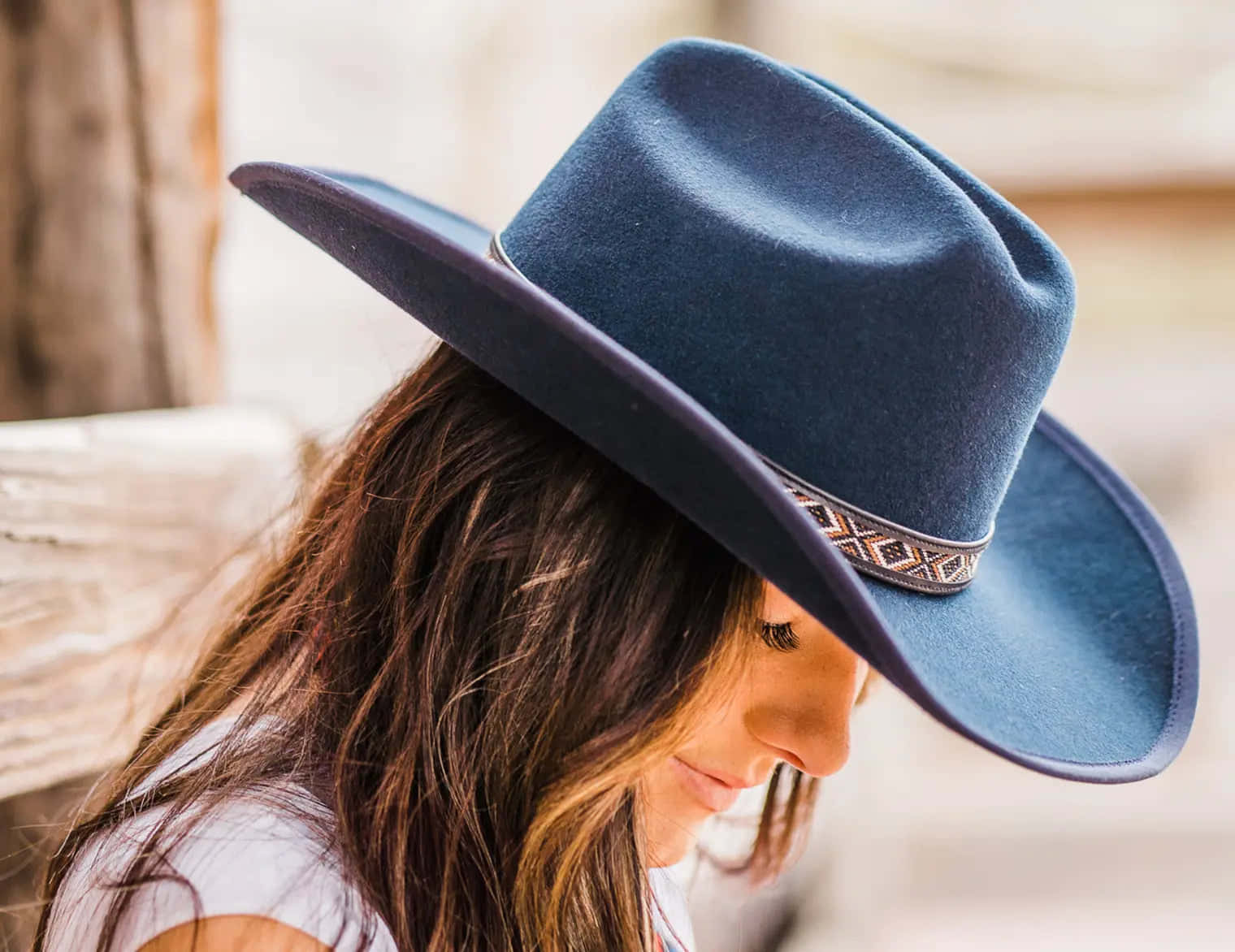A Woman Wearing A Blue Cowboy Hat
