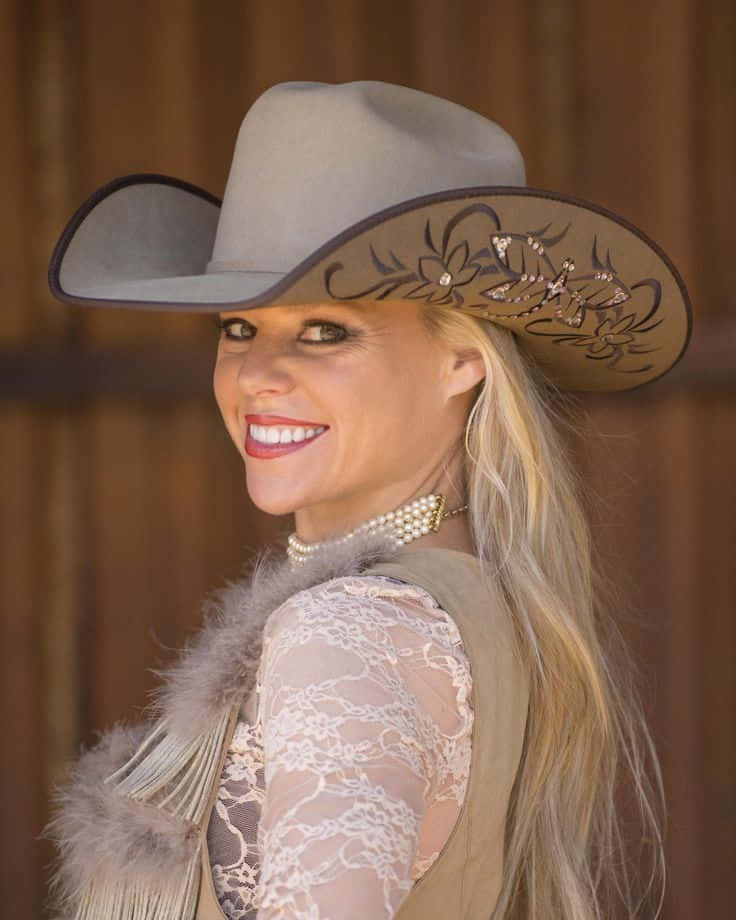 A Woman Wearing A Cowboy Hat And Vest