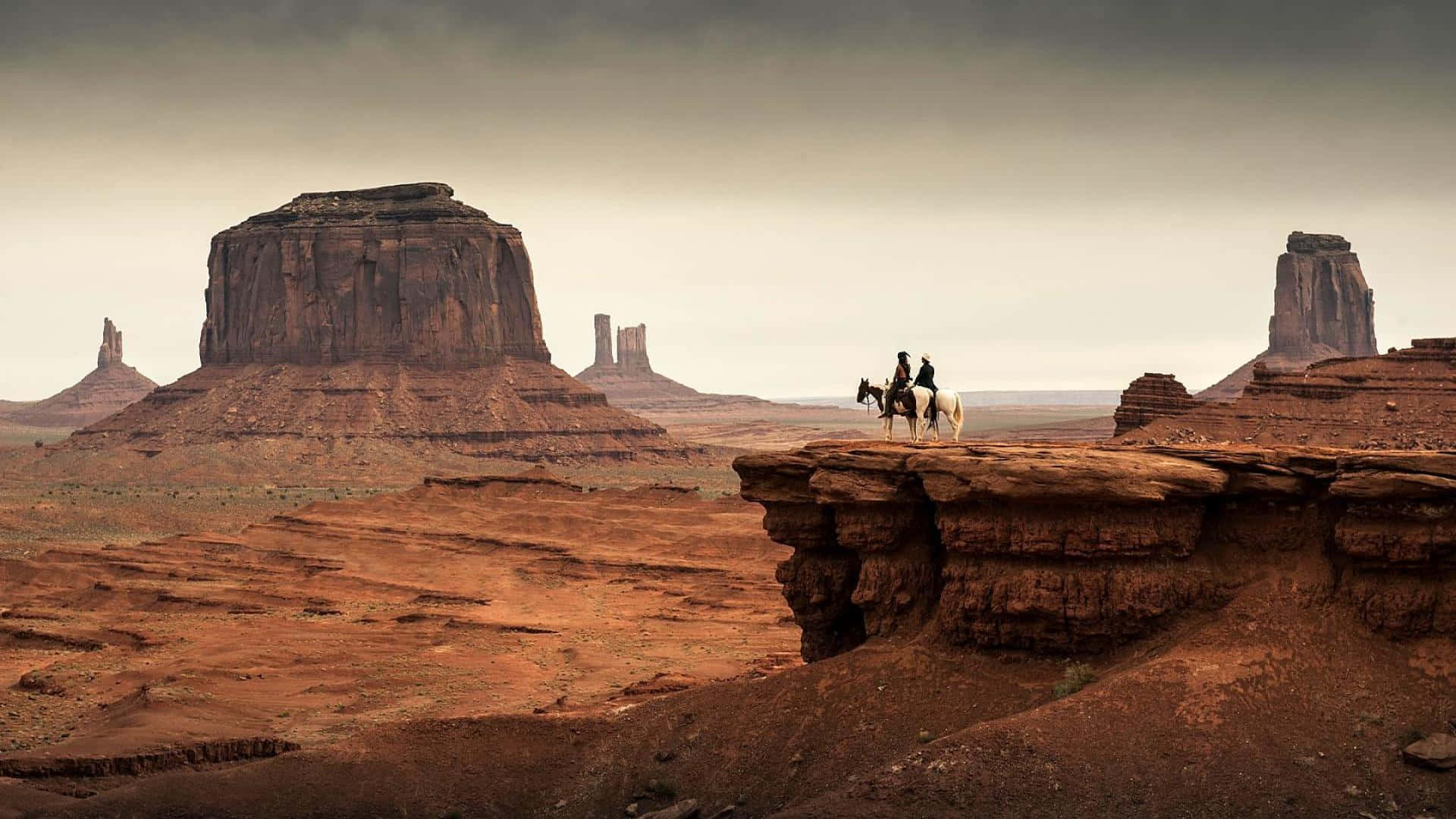 Two Cowboys Riding Horses against a Stunning Sunset