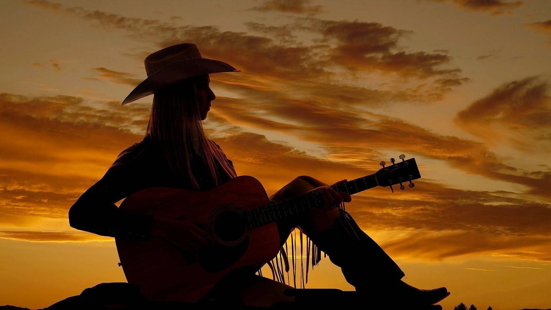 Songbird in the Sunset - The Empowering Power of Country Music Wallpaper