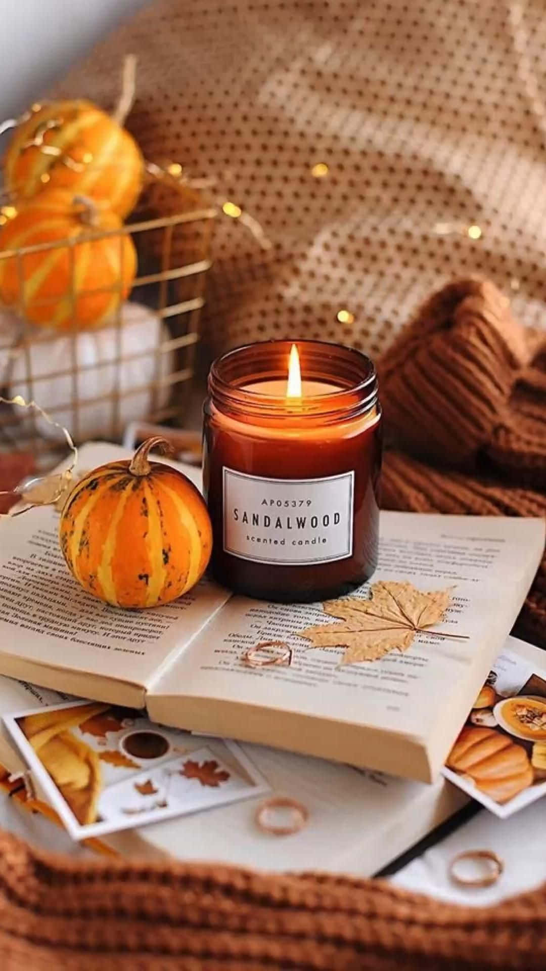 Cozy Autumn Vibeswith Candleand Sweater.jpg Wallpaper
