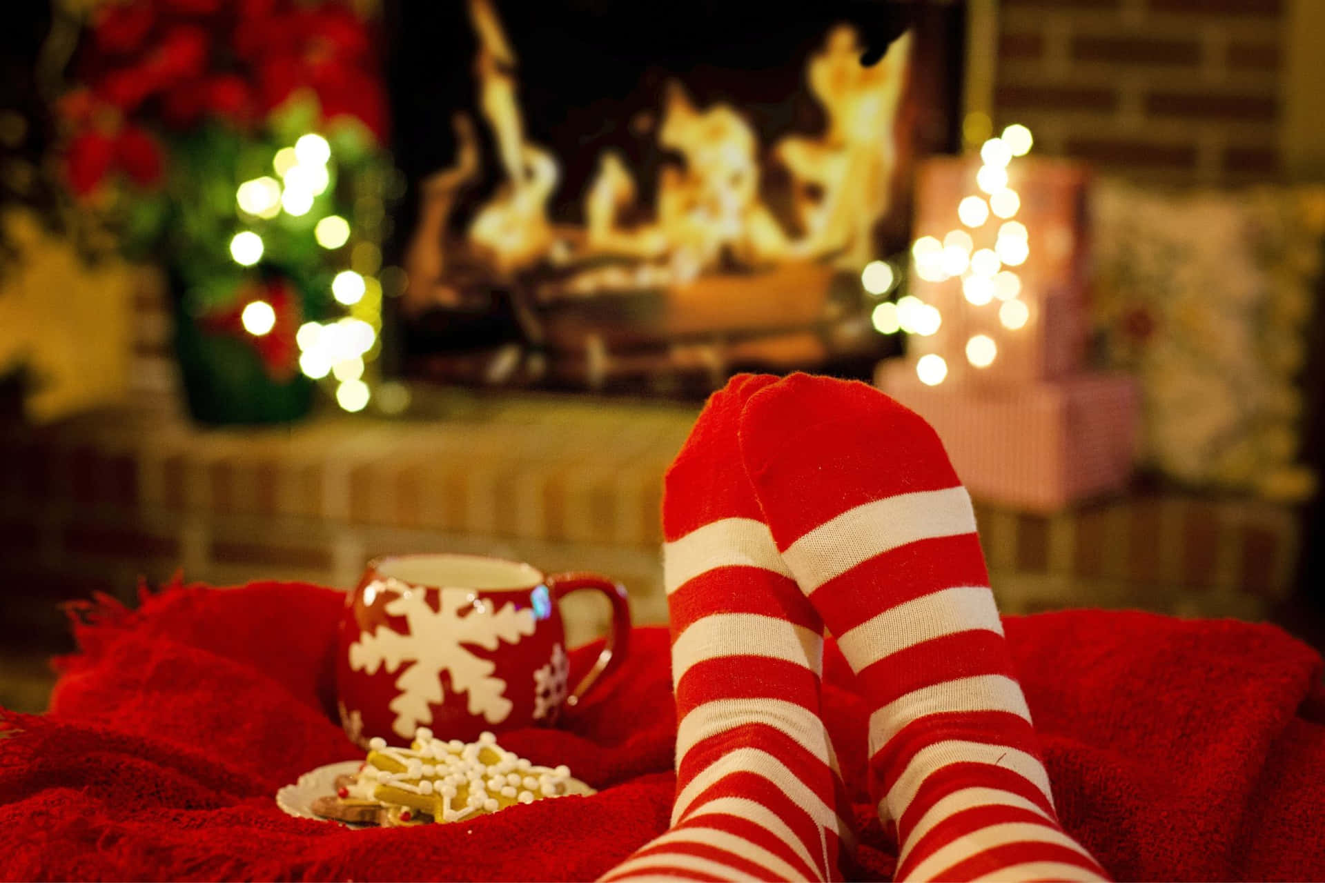 Cozy Christmas Socksby Fireplace Wallpaper
