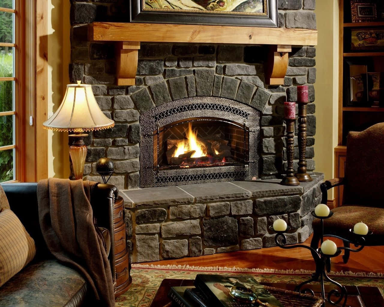 A warm and inviting cozy fire crackling in a stone fireplace Wallpaper