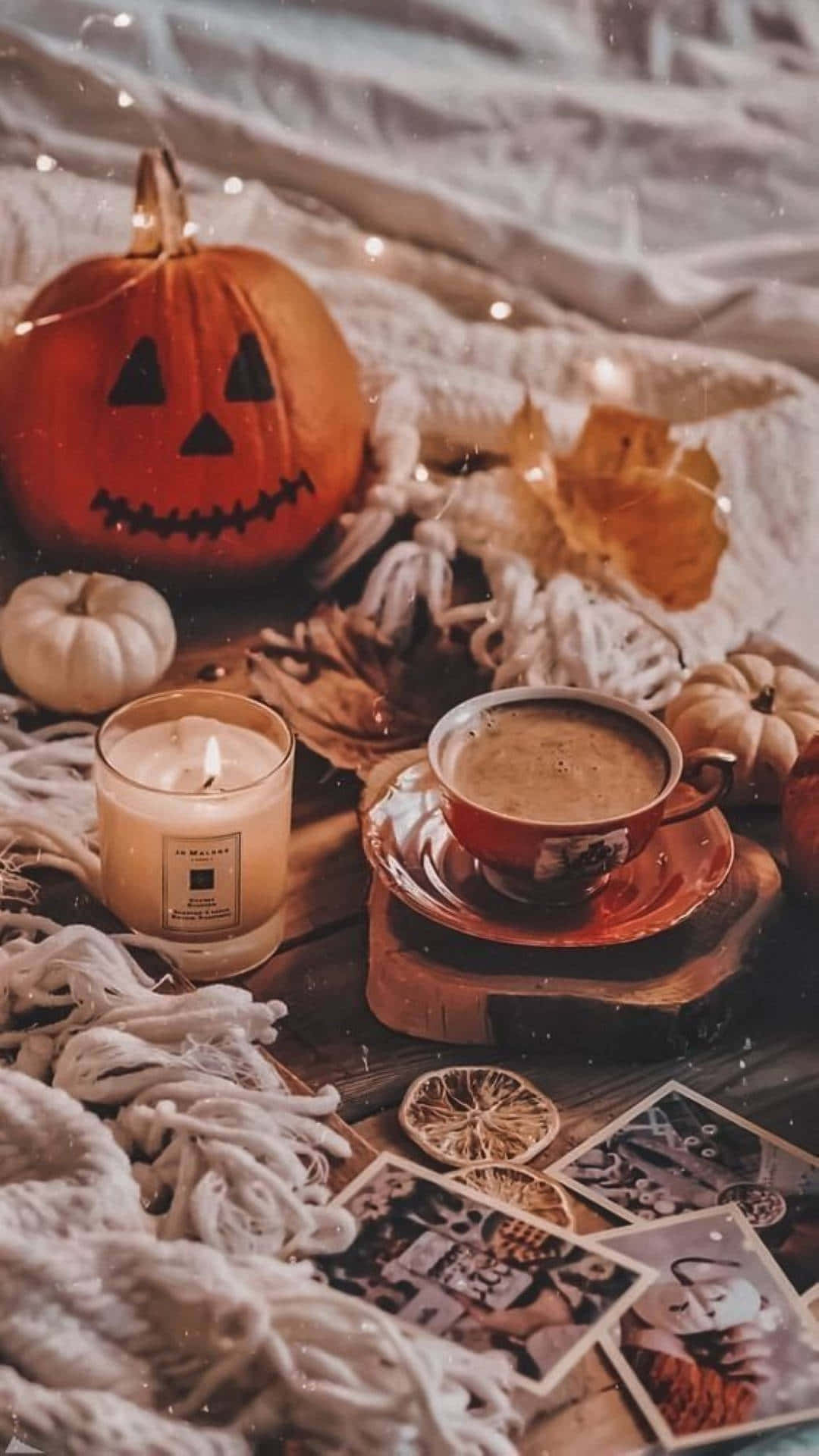 Cozy Halloween Aestheticwith Pumpkinand Candle Wallpaper