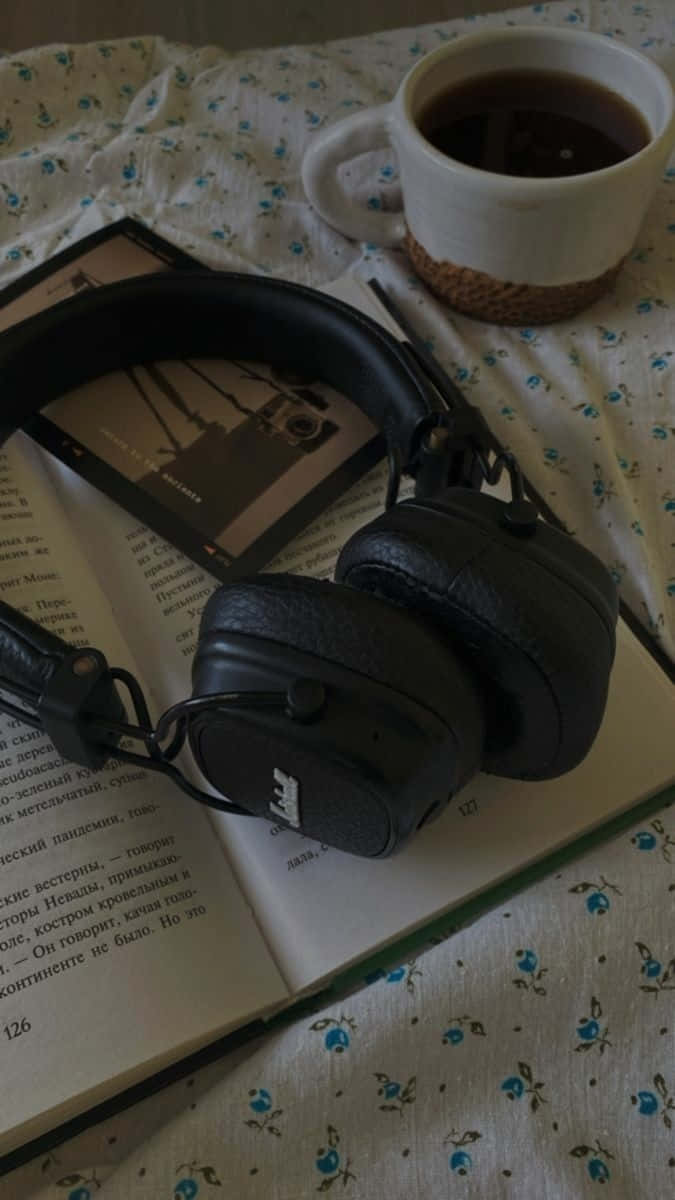 Cozy Reading Setup_with_ Headphones_and_ Tea Wallpaper