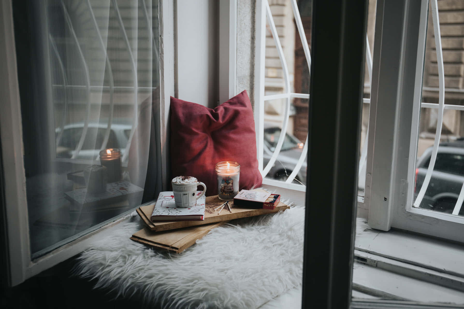 Cozy Window Nookwith Candleand Books.jpg Wallpaper