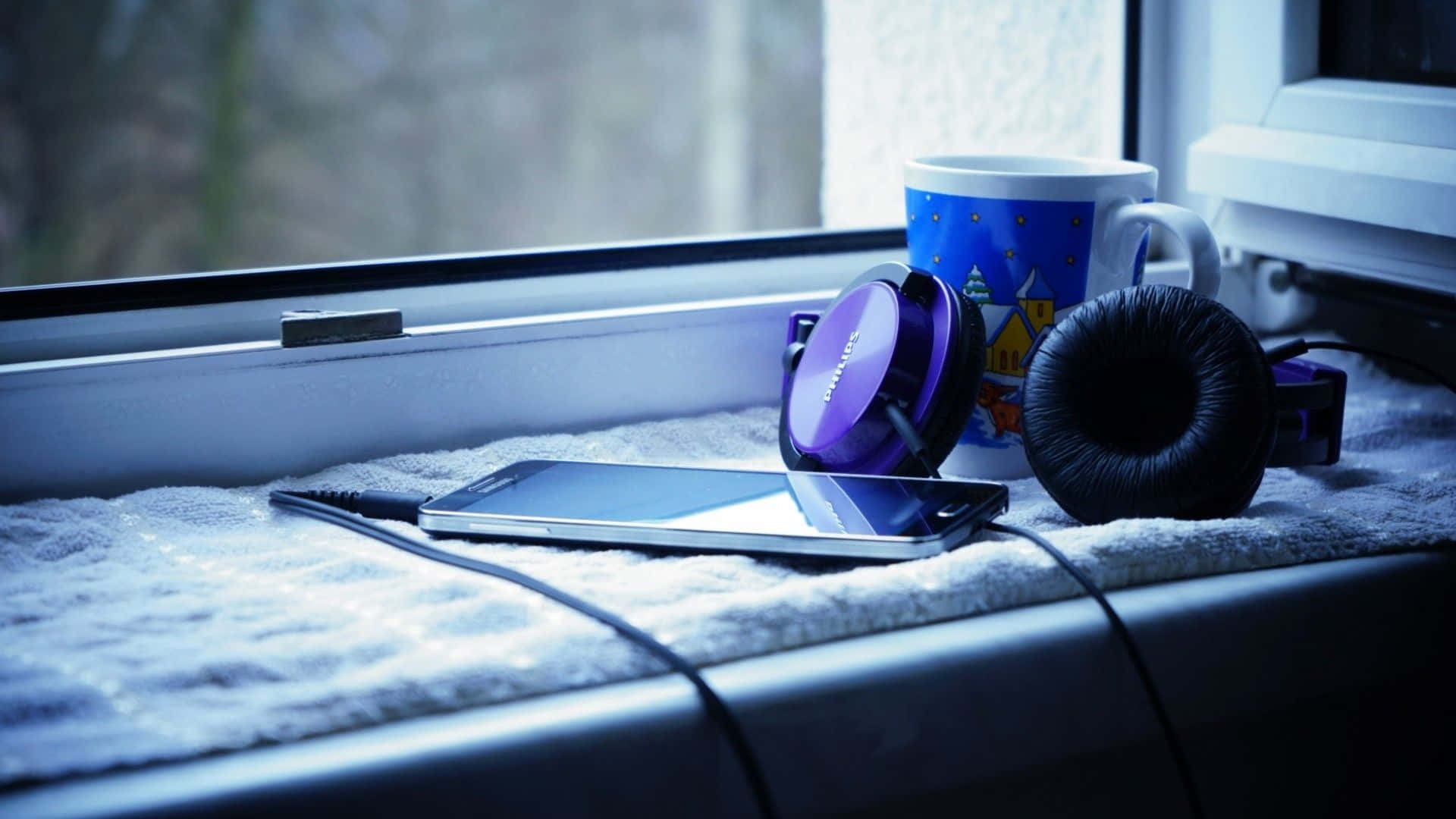 Cozy Window Sillwith Headphonesand Smartphone Wallpaper