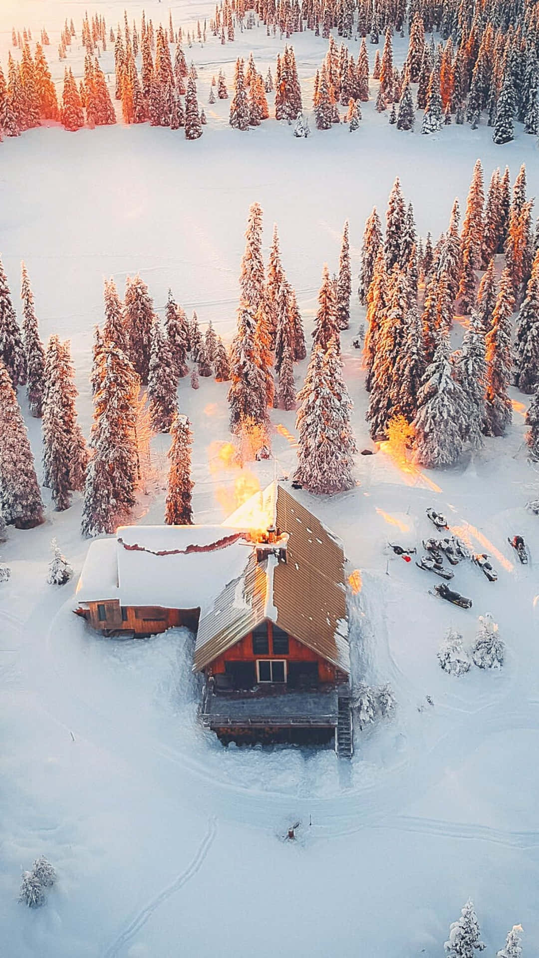 A picture-perfect Cozy Winter Cabin nestled in a winter wonderland Wallpaper