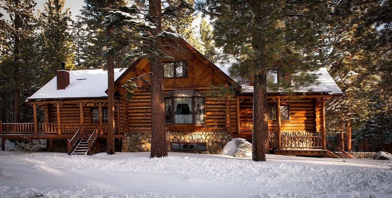 Cozy Winter Cabin in Snowy Forest Wallpaper