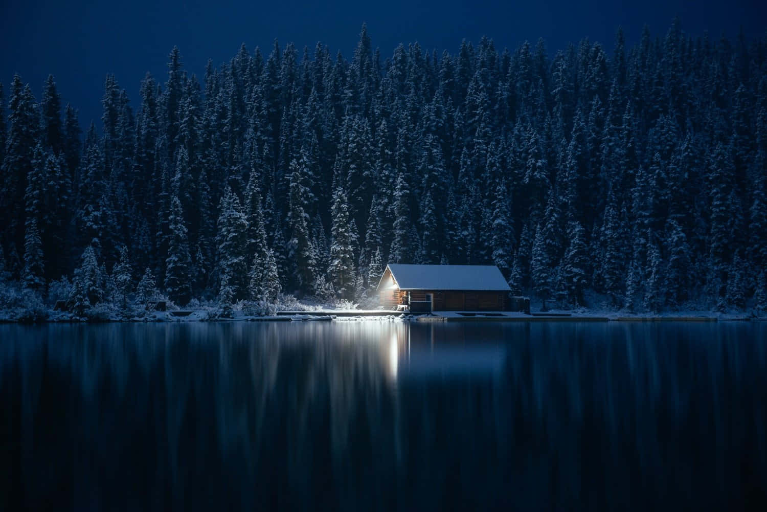 Tranquil Winter Escape - Cozy Cabin Nestled in Snowy Woods Wallpaper