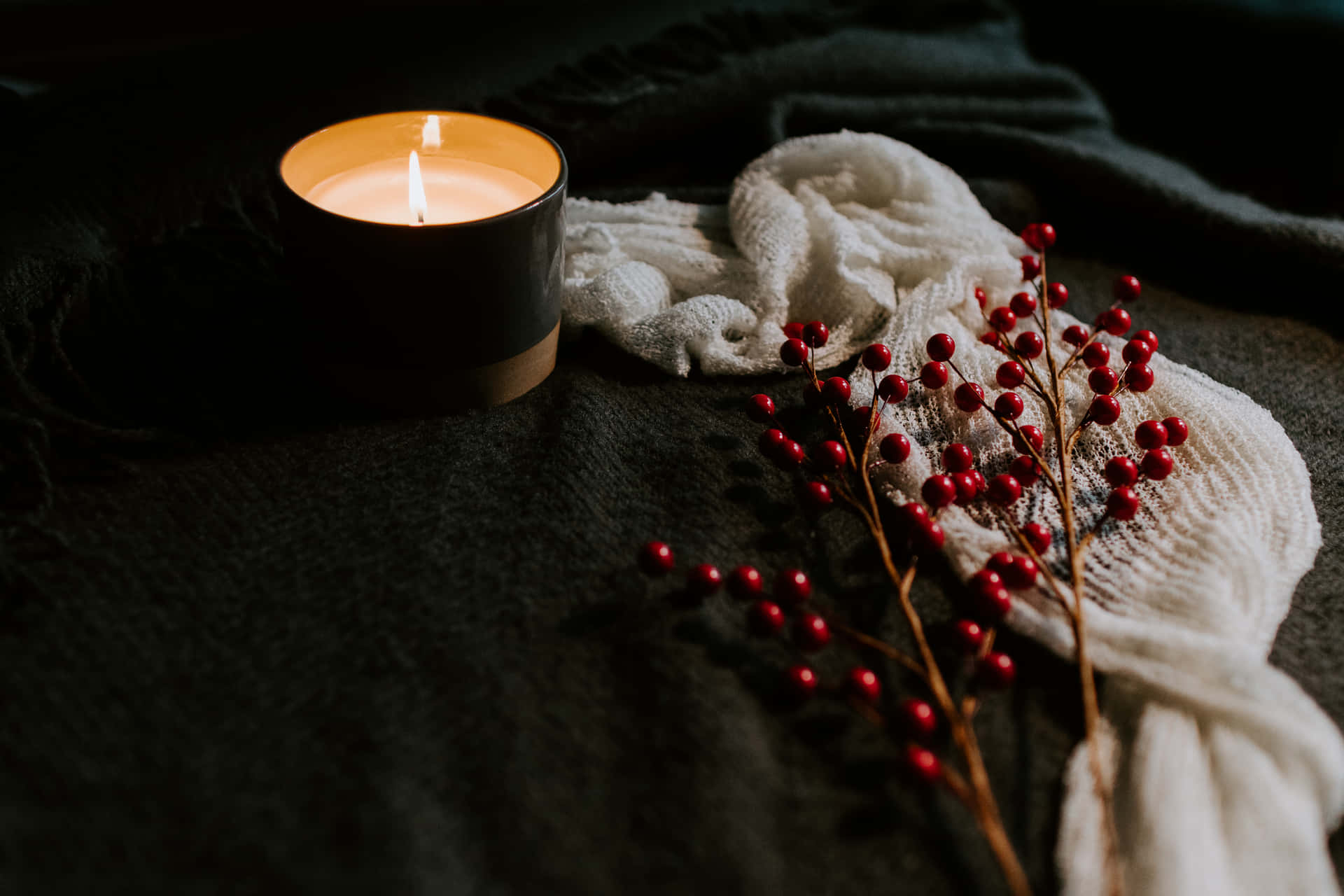 A Candle And Berries On A Bed Wallpaper