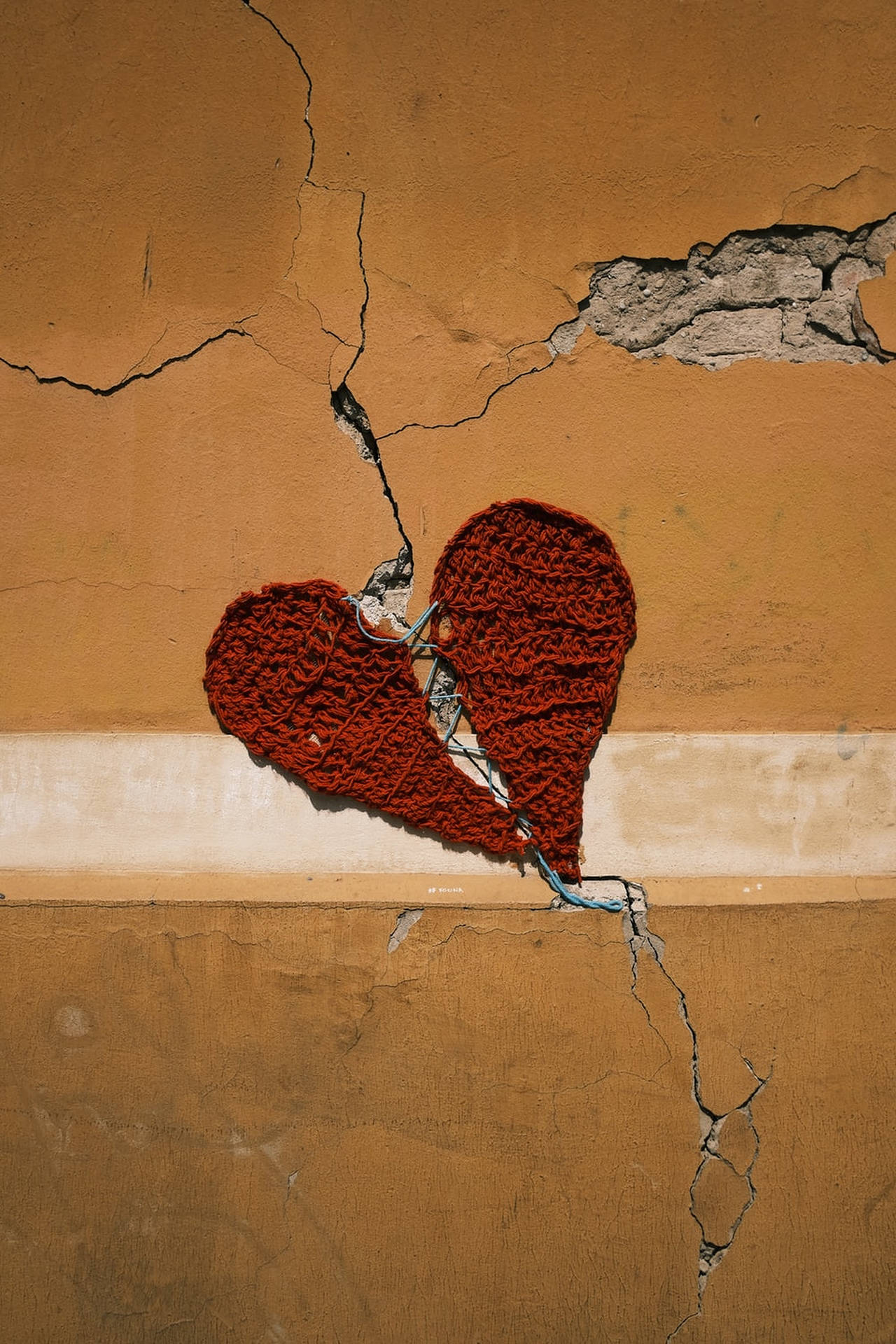 Cracked Heart On Brown Wall Wallpaper