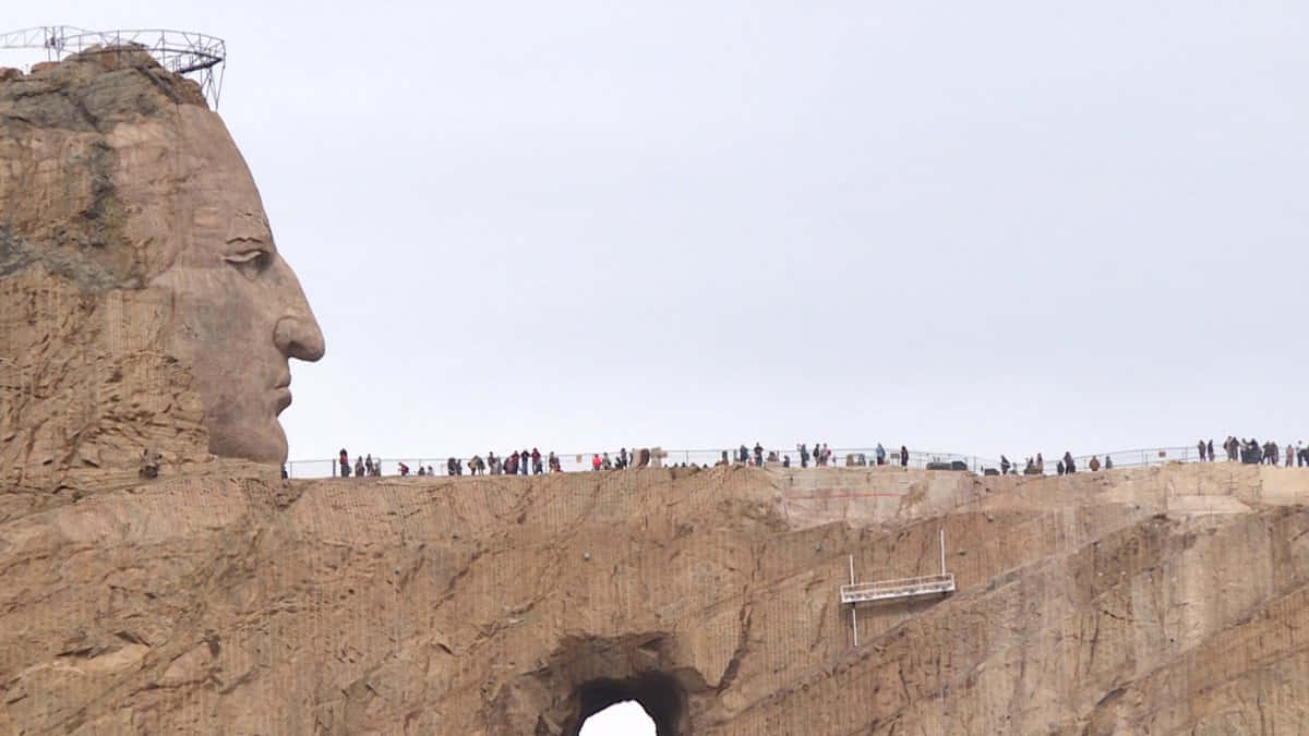 A Large Head Is Carved Into The Side Of A Mountain