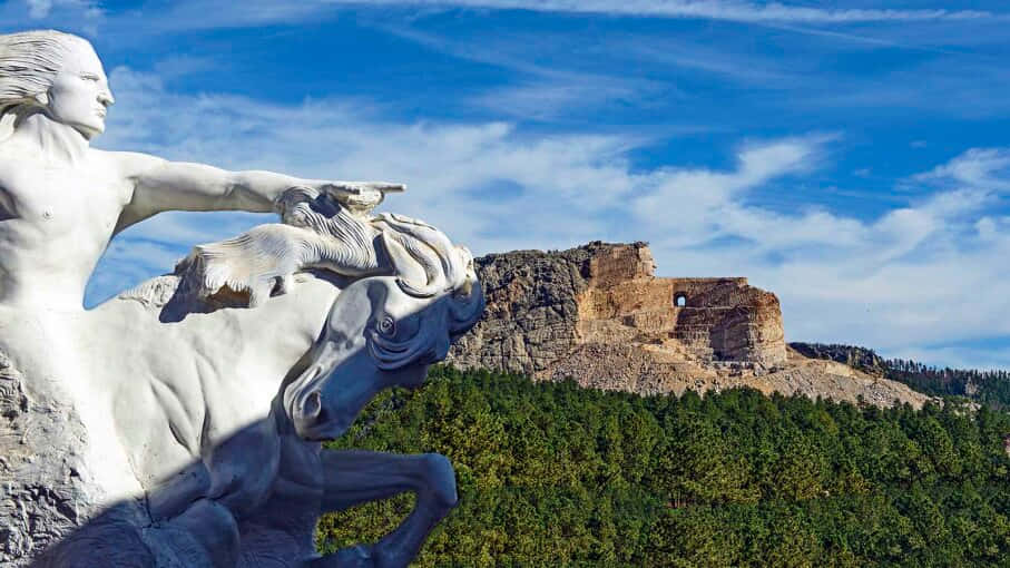A Statue Of A Man Riding A Horse In Front Of A Castle